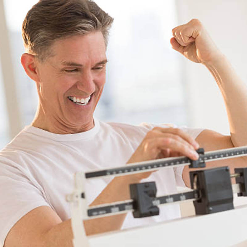 Man celebrating weight loss
